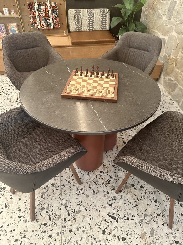 Romer Waikiki Sneak Peek | Renovations Complete Hawaii Calling a chess board on a table with chairs around it