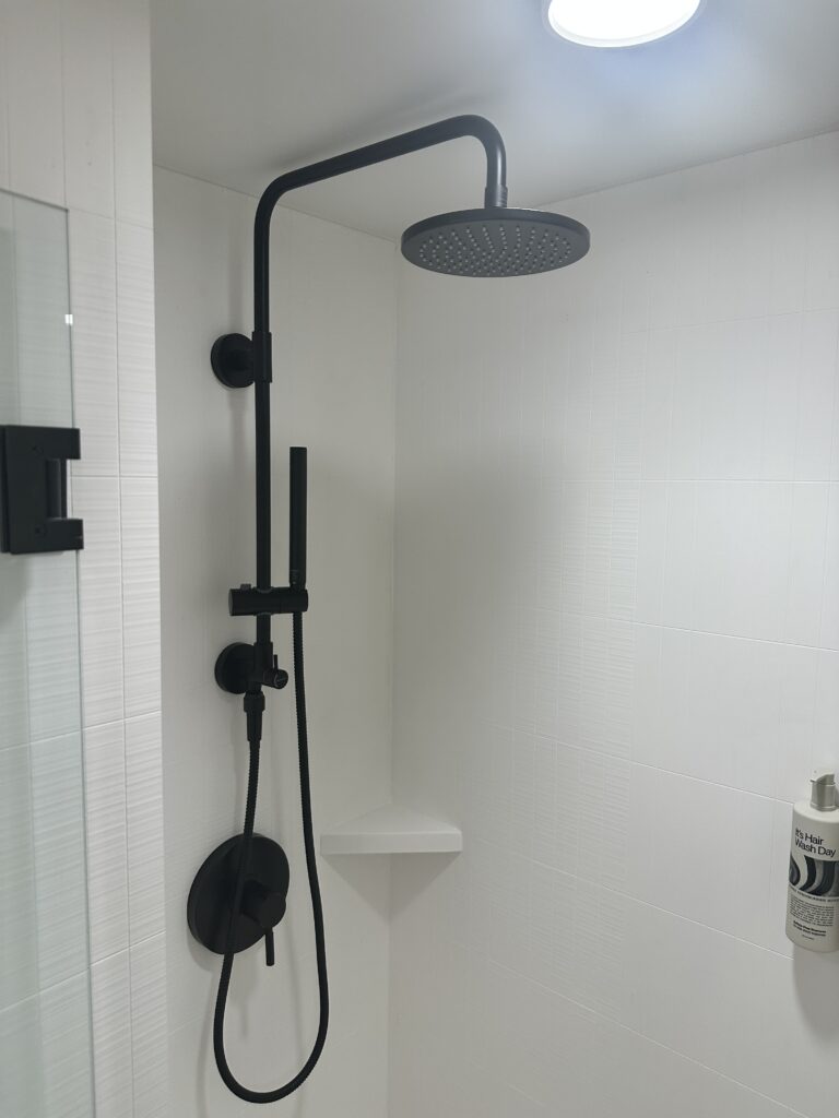Romer Waikiki Sneak Peek | Renovations Complete Hawaii Calling a shower head in a white bathroom