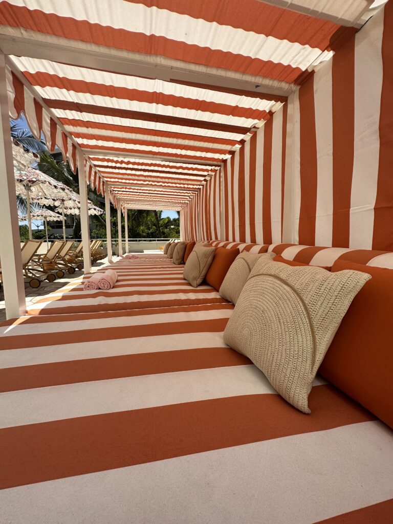Romer Waikiki Sneak Peek | Renovations Complete Hawaii Calling a red and white striped tent with pillows