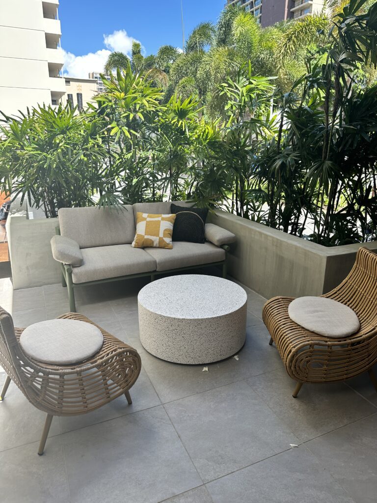 Romer Waikiki Sneak Peek | Renovations Complete Hawaii Calling a patio with a couch and chairs