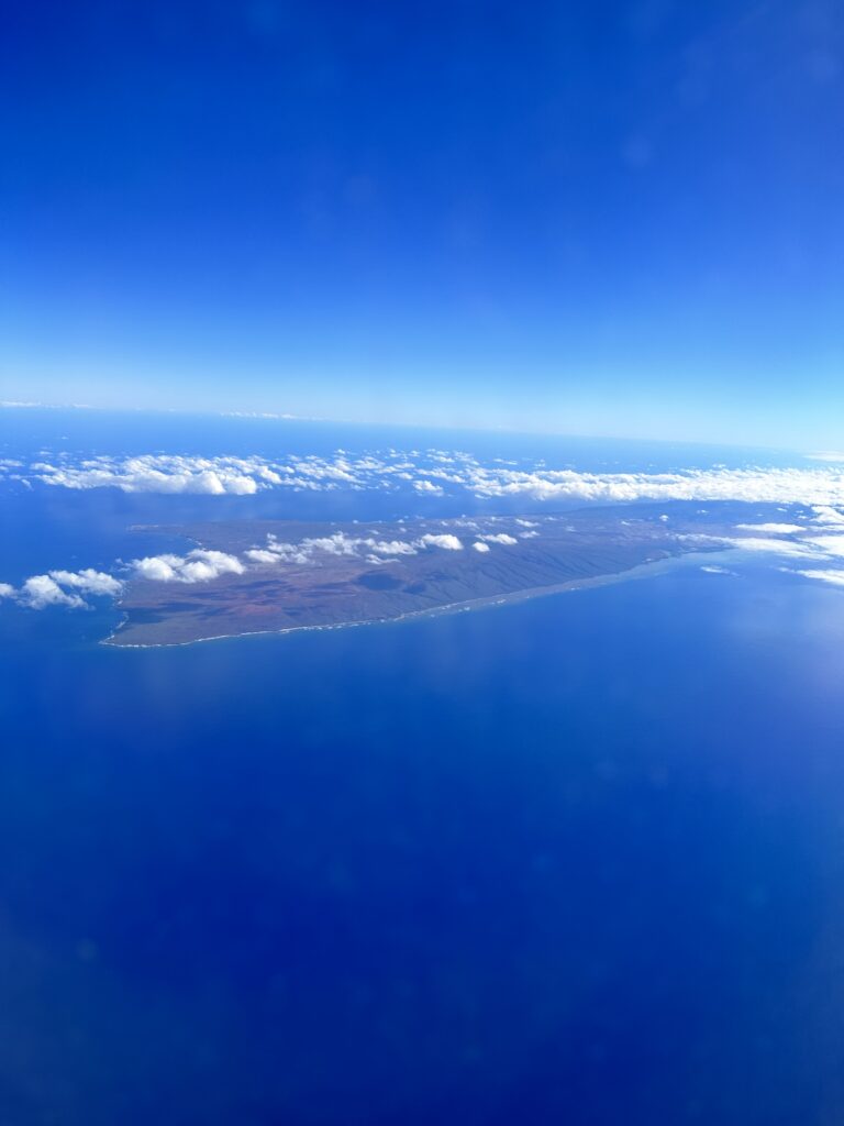 Review: Hawaiian Airlines Boeing 717 Economy HNL-KOA Hawaii Calling an island surrounded by clouds