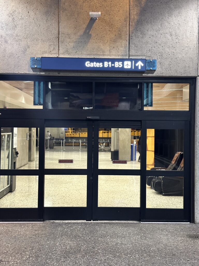 Review: Hawaiian Airlines Honolulu to Hilo | Boeing 717 | HNL-ITO Hawaii Calling a glass doors with a sign on the front