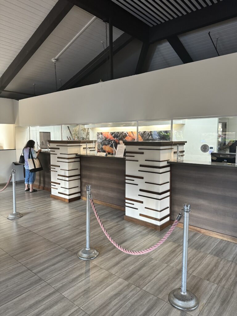 Hawai'i Travel News November 2023 | New Hotels & Flight Updates Hawaii Calling a woman standing in front of a counter