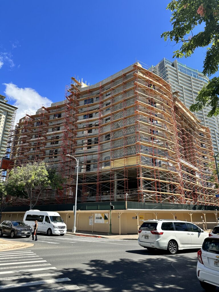 Hawai'i Travel News November 2023 | New Hotels & Flight Updates Hawaii Calling a building under construction with cars and people walking around