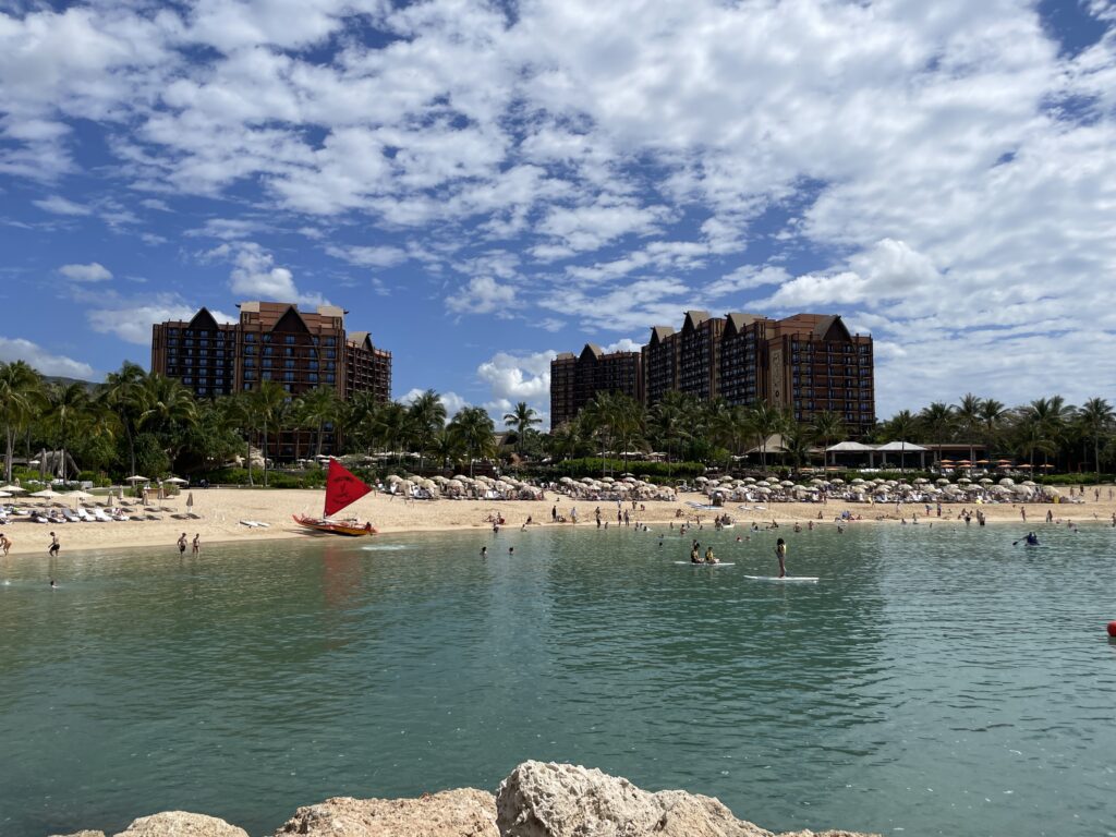 15 Best Beachfront Hotels On Oahu (2025) | Waterfront Bliss Hawaii Calling a beach with people and a boat