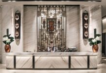 Guide to Hilton Impresario: Exclusive Perks For Luxury Stays a man behind a counter