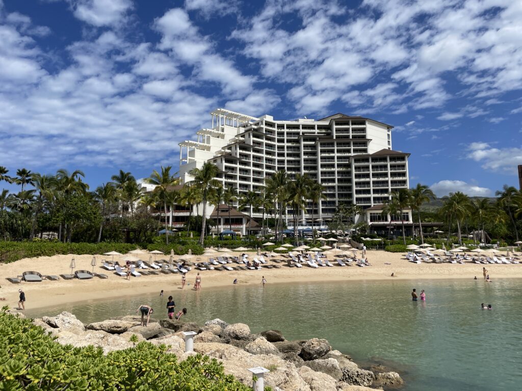 15 Best Beachfront Hotels On Oahu (2025) | Waterfront Bliss Hawaii Calling a beach with a large building and people on it
