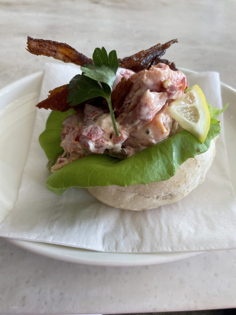 25 Best Restaurants in Hawaii for (2025) Hawaii Calling a sandwich with bacon and lettuce on a plate