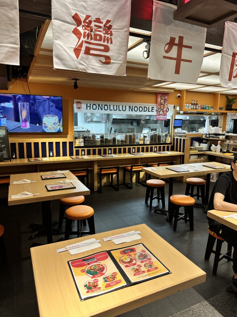 STIX Waikiki: A Foodie's Paradise in the Heart of Waikiki Beach Hawaii Calling a man sitting at tables in a restaurant
