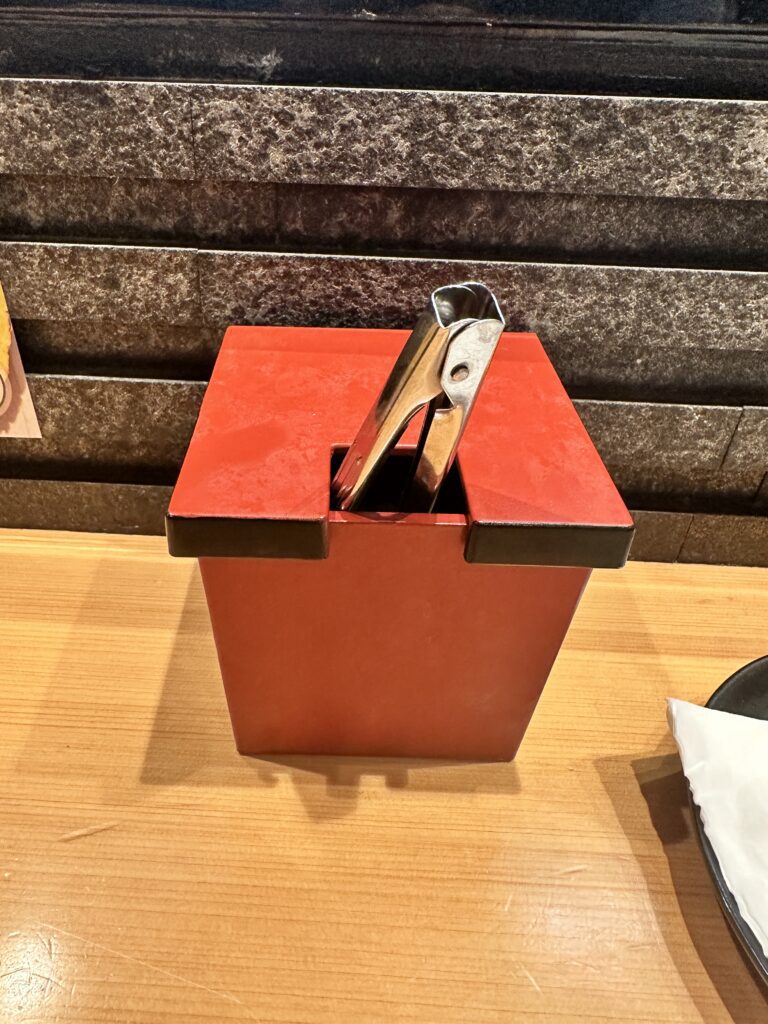STIX Waikiki: A Foodie's Paradise in the Heart of Waikiki Beach Hawaii Calling a metal tongs in a red container