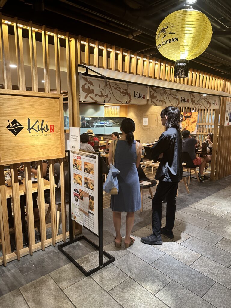 STIX Waikiki: A Foodie's Paradise in the Heart of Waikiki Beach Hawaii Calling a man and woman standing in a restaurant