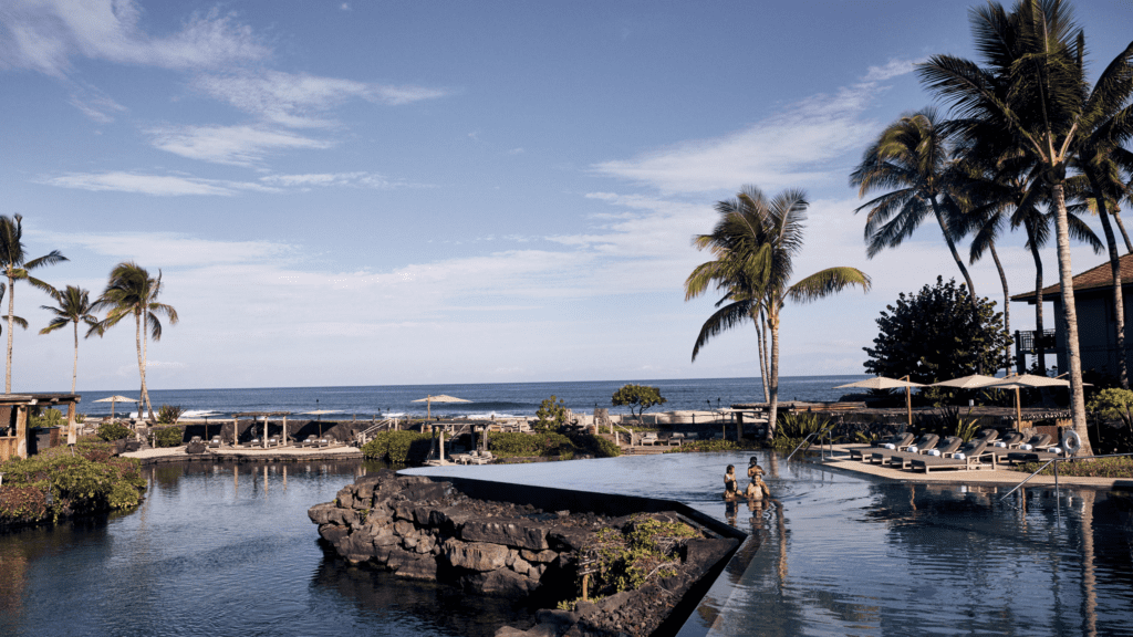 13 Best Luxury Hotels in Hawaii (2025) Hawaii Calling people in a pool with palm trees and a beach