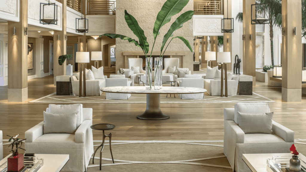 13 Best Luxury Hotels in Hawaii (2025) Hawaii Calling a large room with white furniture and a large table with a plant in it