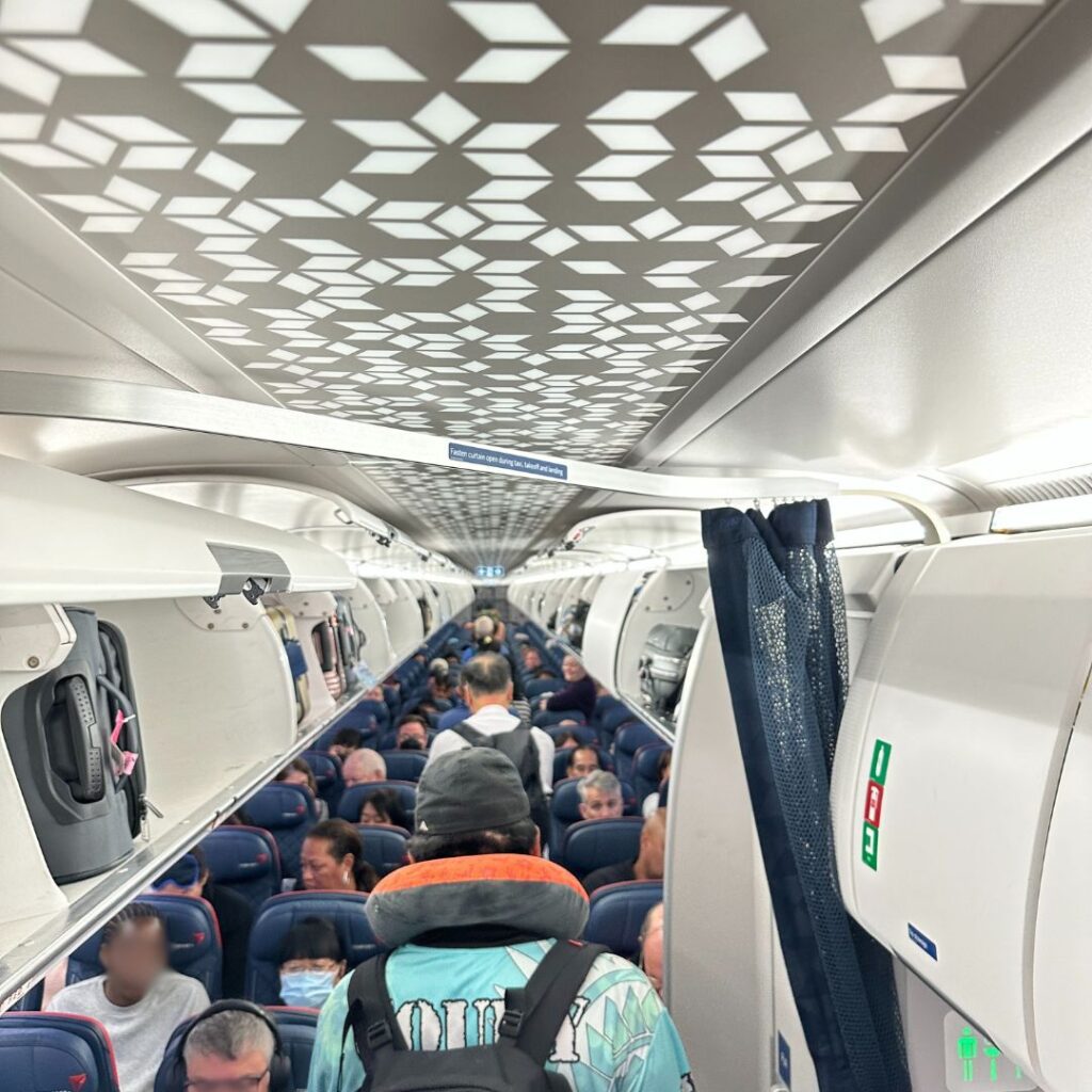 Review: Delta Airlines Economy A321NEO HNL-SEA (Honolulu to Seattle) Hawaii Calling a group of people on an airplane