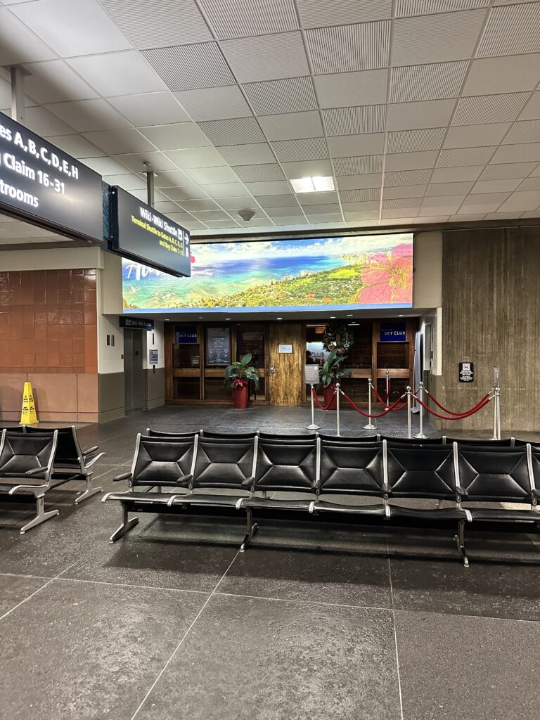 Delta Sky Club Honolulu | Guide & Review (2025) Hawaii Calling a row of chairs in a airport