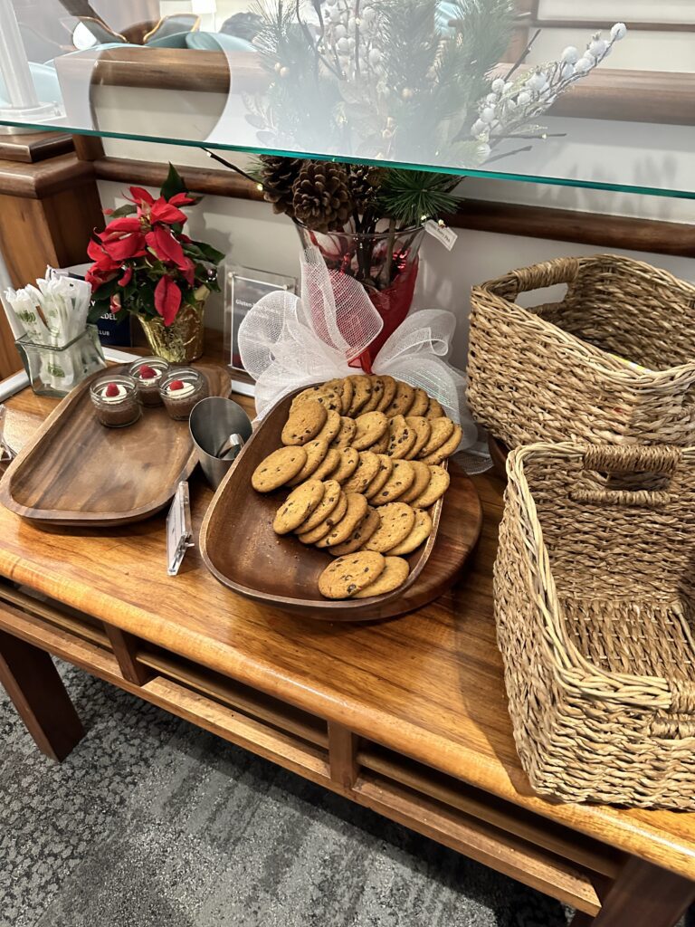 Delta Sky Club Honolulu | Guide & Review (2025) Hawaii Calling a table with a tray of cookies and baskets