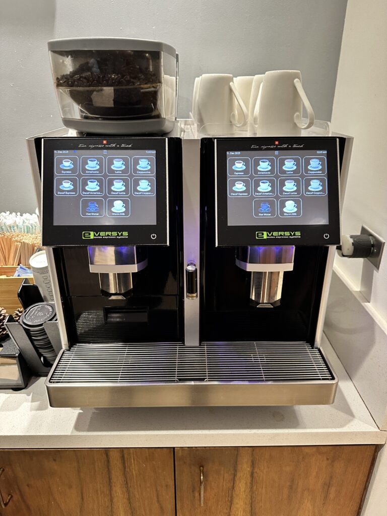 Delta Sky Club Honolulu | Guide & Review (2025) Hawaii Calling a machine with a screen and a container with coffee beans