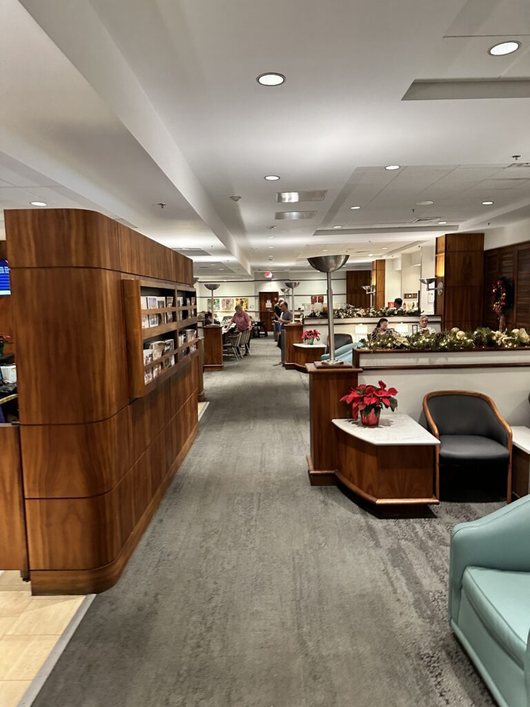 Delta Sky Club Honolulu | Guide & Review (2025) Hawaii Calling a lobby with a desk and chairs