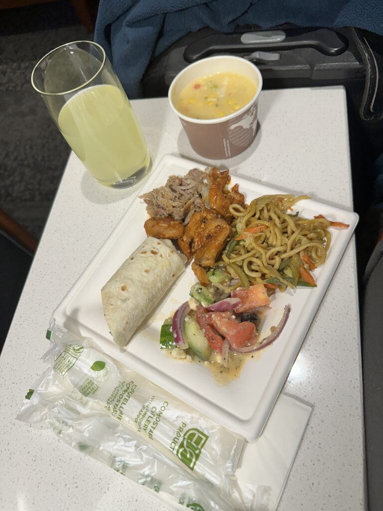 Delta Sky Club Honolulu | Guide & Review (2025) Hawaii Calling a plate of food and a drink on a table