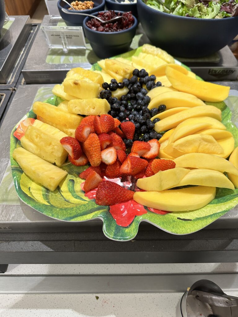 Delta Sky Club Honolulu | Guide & Review (2025) Hawaii Calling a plate of fruit on a counter