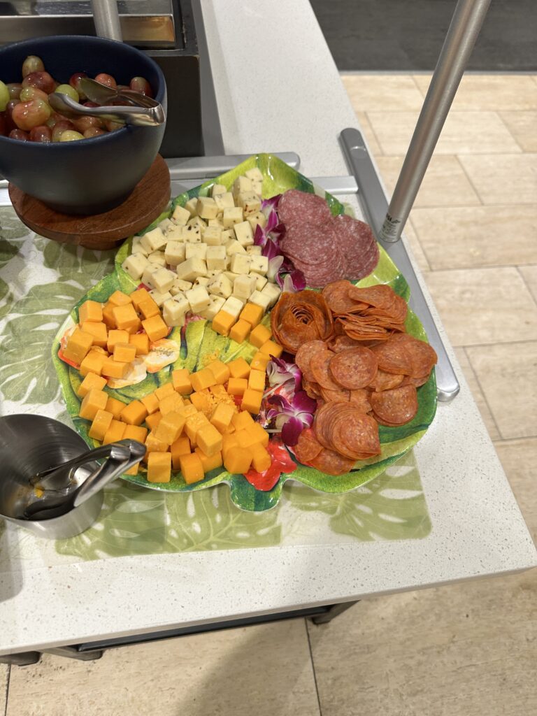 Delta Sky Club Honolulu | Guide & Review (2025) Hawaii Calling a plate of food on a table