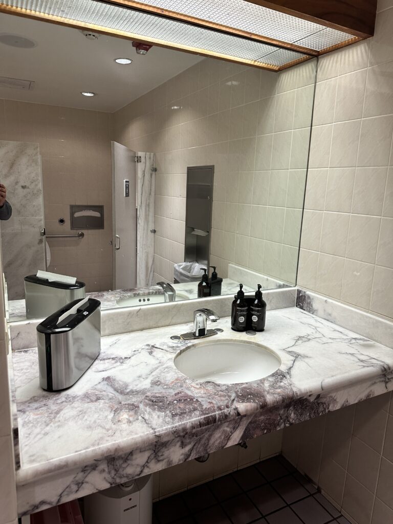Delta Sky Club Honolulu | Guide & Review (2025) Hawaii Calling a bathroom with a marble countertop