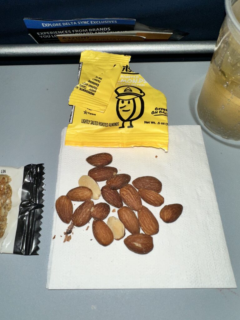 Review: Delta Airlines Economy A321NEO HNL-SEA (Honolulu to Seattle) Hawaii Calling a group of almonds on a napkin