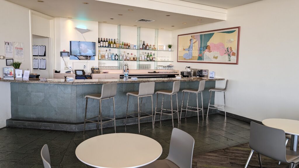 United Airlines Club Honolulu | Unique & Spacious Hawaii Calling a bar with a counter and chairs