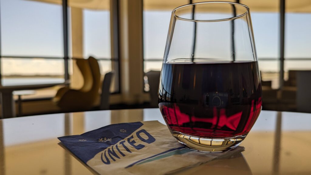United Airlines Club Honolulu | Unique & Spacious Hawaii Calling a glass of red liquid on a napkin