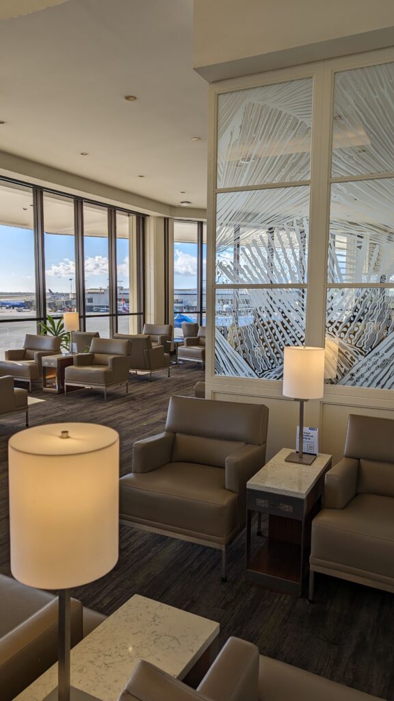 United Airlines Club Honolulu | Unique & Spacious Hawaii Calling a room with chairs and a lamp