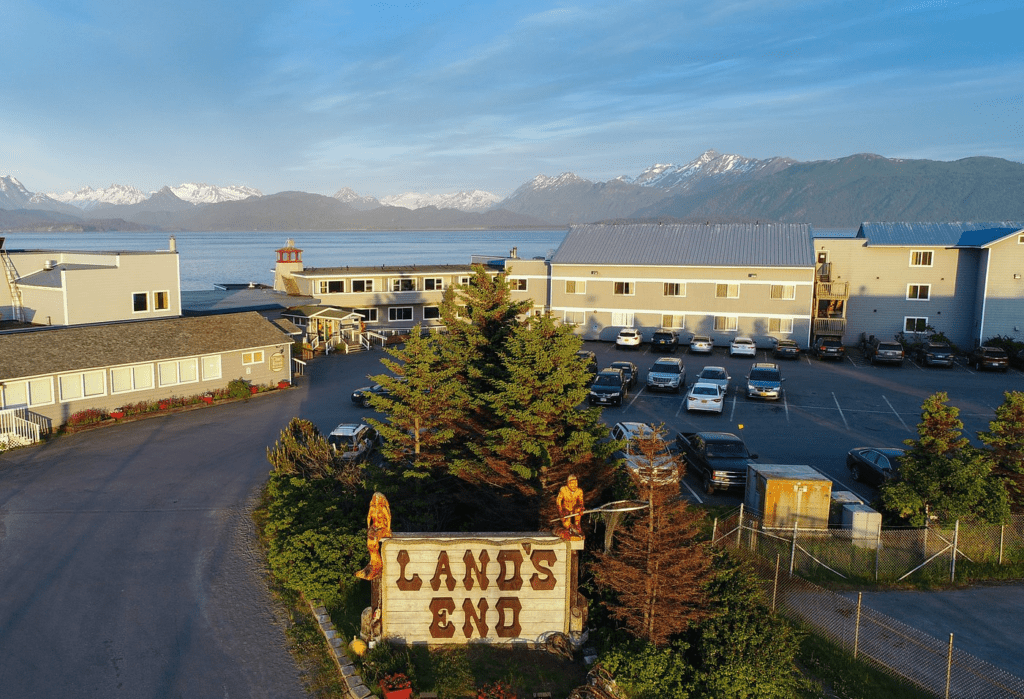 The 5 Best Budget Hotels in Alaska (2024) Hawaii Calling a parking lot with a sign and trees and a large body of water