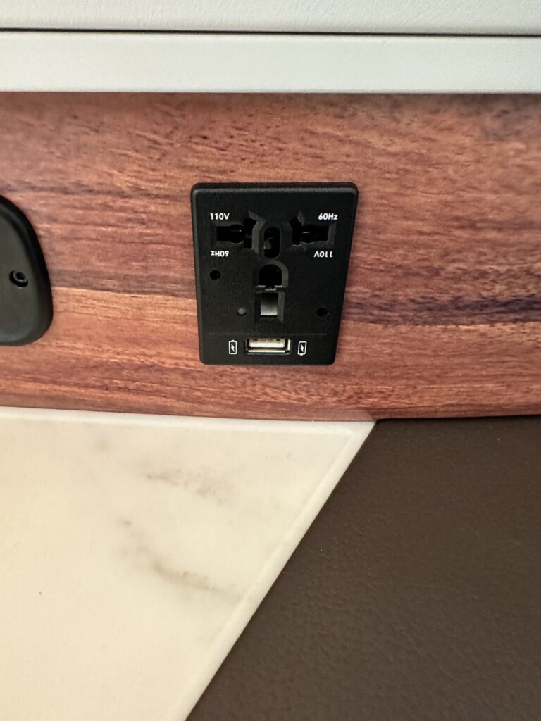 Hawaiian Airlines Boeing 787 Dreamliner Walk Through Hawaii Calling a black outlet on a wood surface