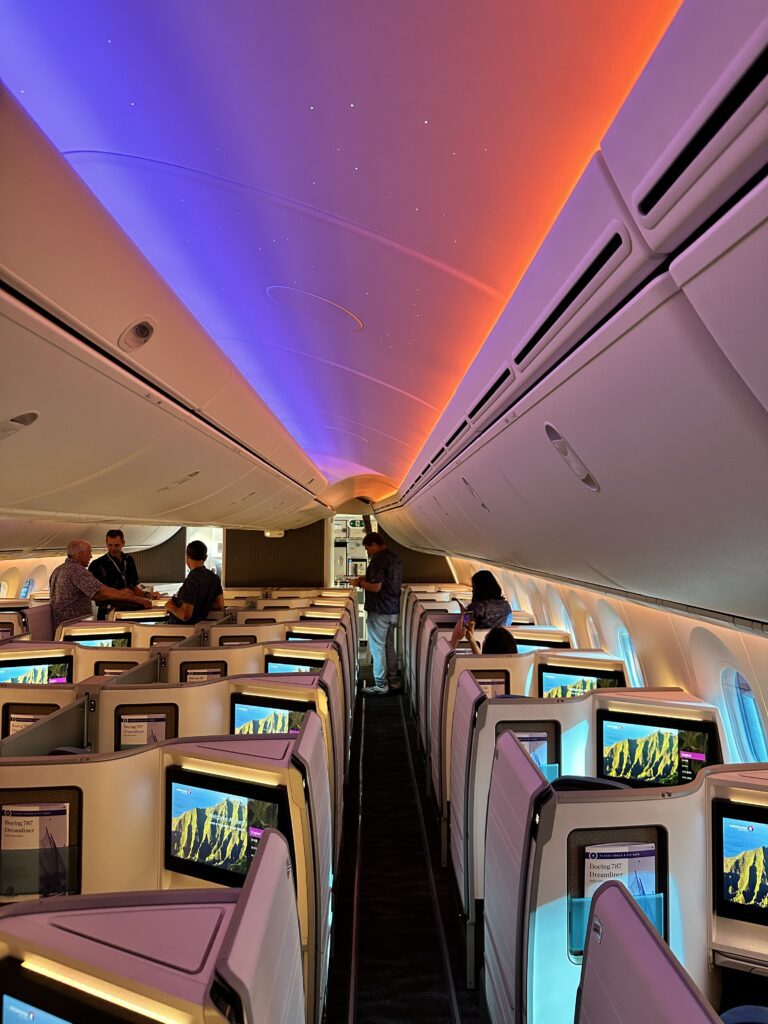 Hawaiian Airlines Boeing 787 Dreamliner Walk Through Hawaii Calling a group of people in an airplane