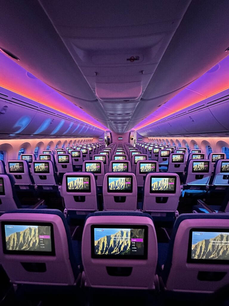 Hawaiian Airlines Boeing 787 Dreamliner Walk Through Hawaii Calling rows of seats with monitors on them