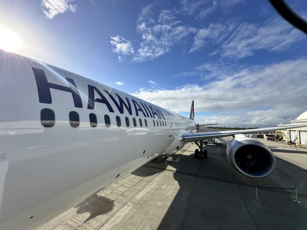 Hawaiian Airlines Boeing 787 Dreamliner Walk Through Hawaii Calling a large white airplane with blue writing on it