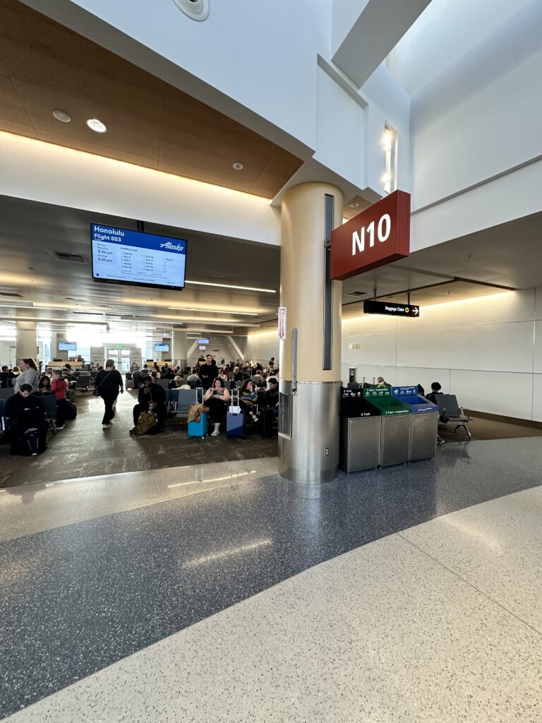 Review: Alaska Airlines Boeing 737 Max 9 First Class SEA-HNL Hawaii Calling a group of people sitting in a terminal