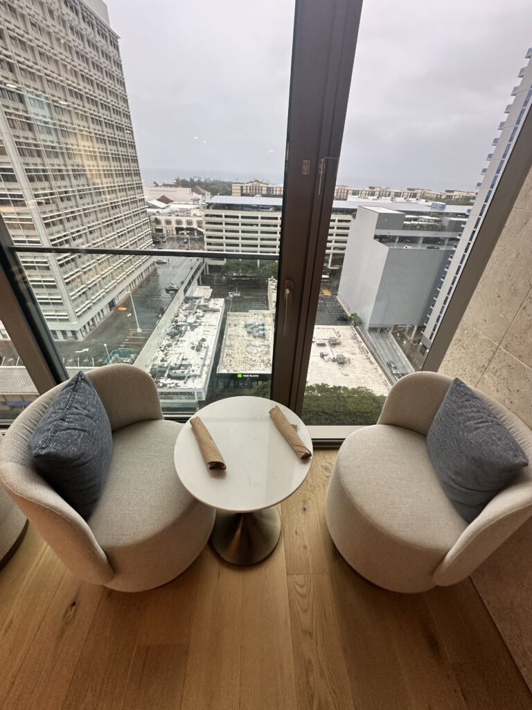 Review: Renaissance Honolulu Hotel & Spa | Oahu's Newest Hotel Hawaii Calling two chairs and a table in a room with a view of a city