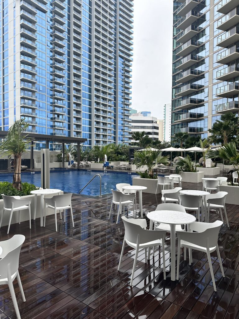 Review: Renaissance Honolulu Hotel & Spa | Oahu's Newest Hotel Hawaii Calling a pool with tables and chairs in front of a building