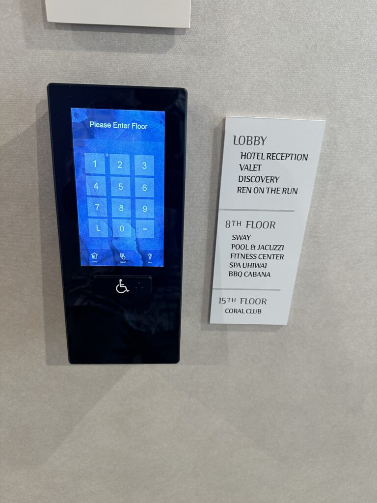 Review: Renaissance Honolulu Hotel & Spa | Oahu's Newest Hotel Hawaii Calling a electronic device with a blue screen and a white sign