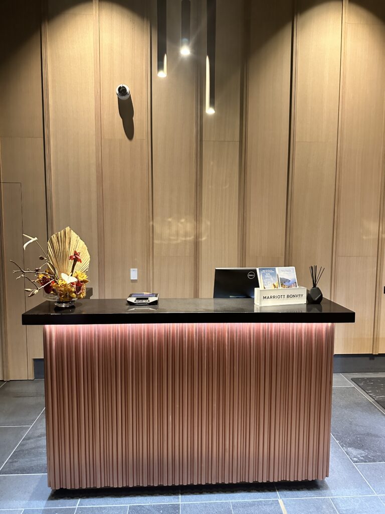 Review: Renaissance Honolulu Hotel & Spa | Oahu's Newest Hotel Hawaii Calling a desk with a flower arrangement on it