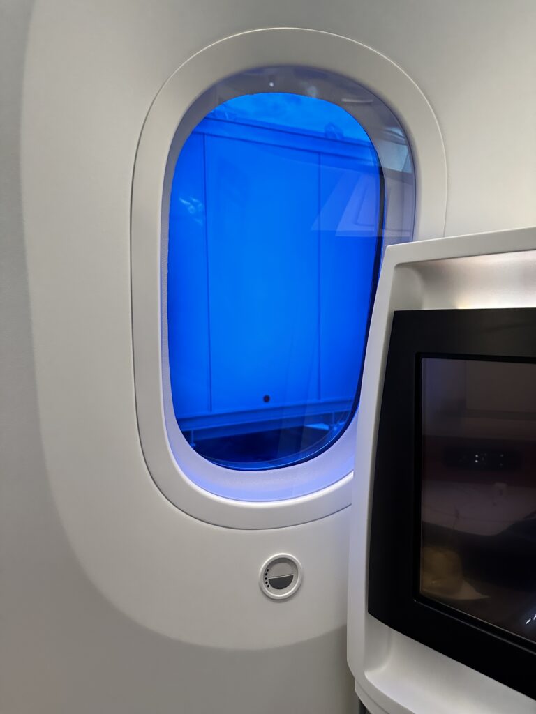 A First Class Experience on Hawaiian Airlines Boeing 787 Dreamliner | Leihōkū Suites | HNL-SFO Hawaii Calling a window in a plane