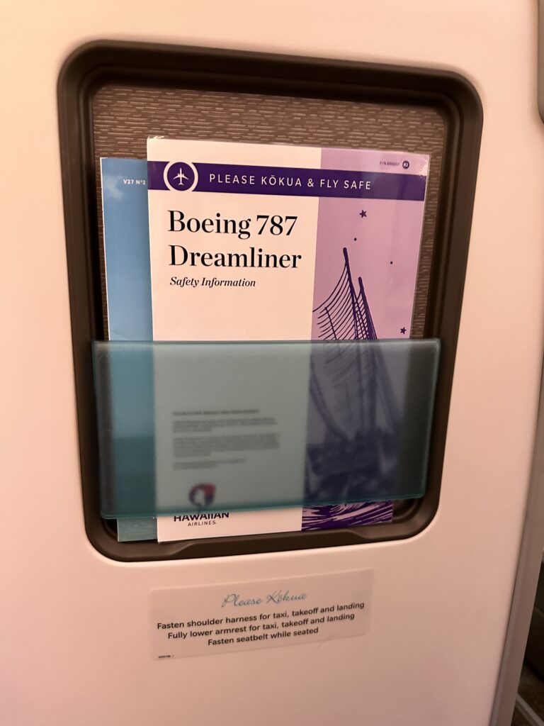 A First Class Experience on Hawaiian Airlines Boeing 787 Dreamliner | Leihōkū Suites | HNL-SFO Hawaii Calling a brochure in a holder