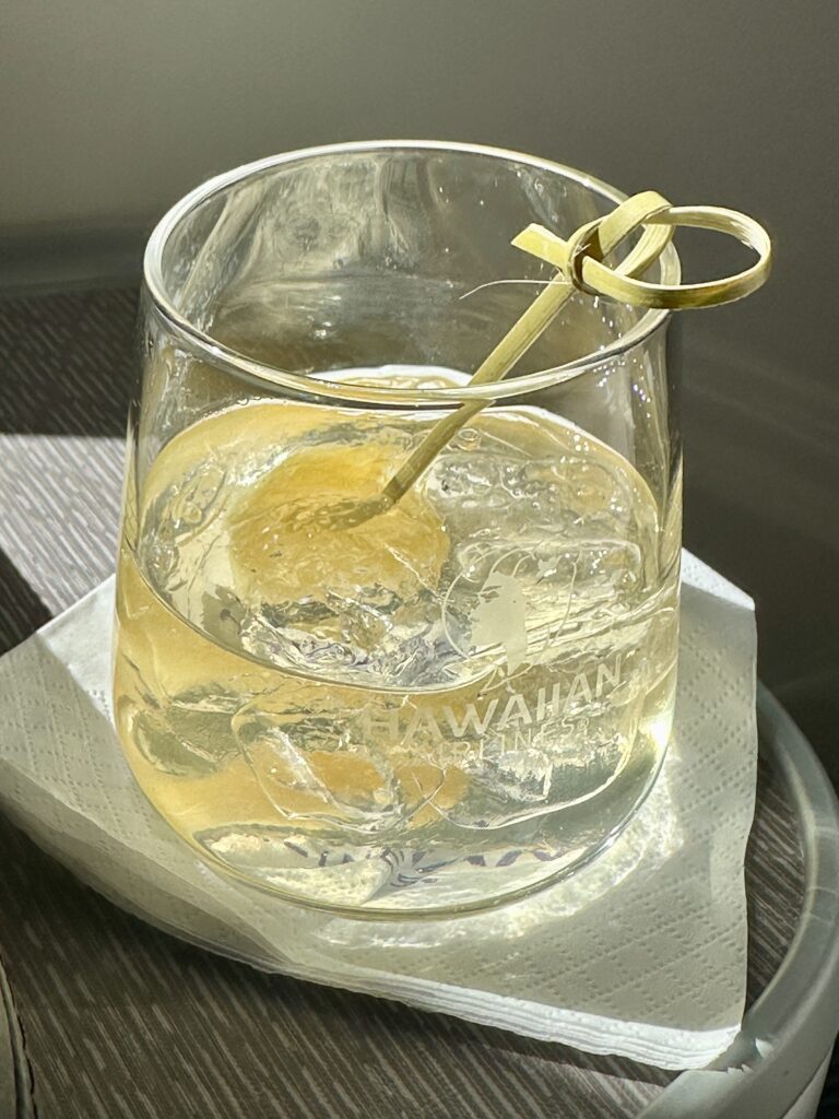A First Class Experience on Hawaiian Airlines Boeing 787 Dreamliner | Leihōkū Suites | HNL-SFO Hawaii Calling a glass with liquid and a straw in it