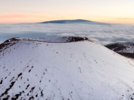 a snow covered mountain top of Mauna Kea making it one of the best islands to visit in Hawai'i in january
