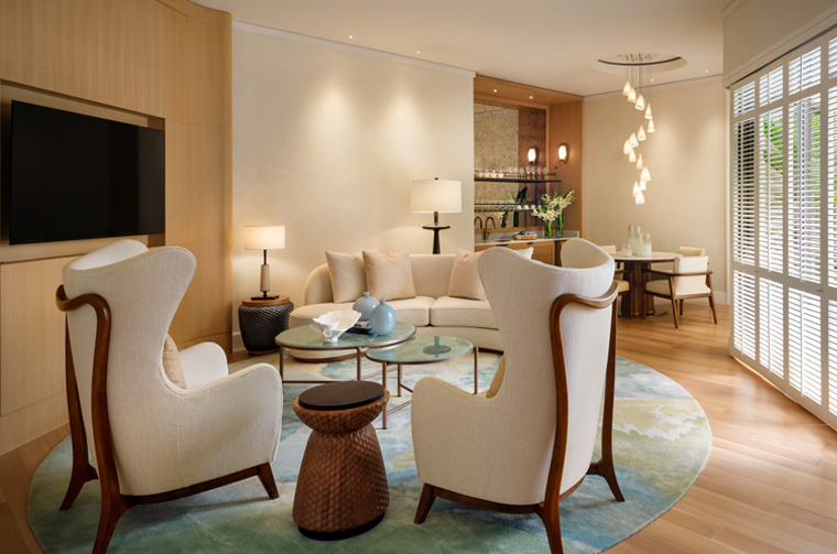 Halekulani Unveils Two New Premier Suites: A New Level of Luxury in Waikiki Hawaii Calling a living room with white chairs and a table