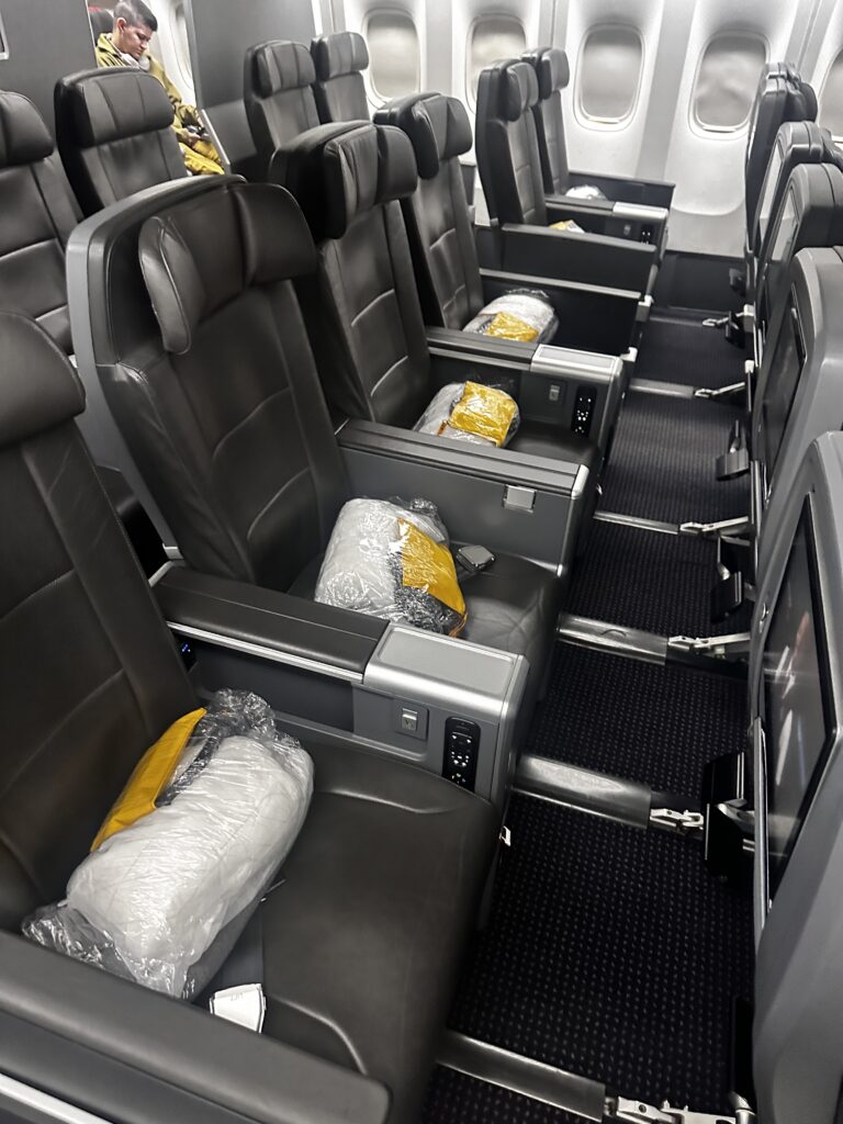 American Airlines DFW-HNL Premium Economy Review | Boeing 777 Hawaii Calling a row of seats in an airplane