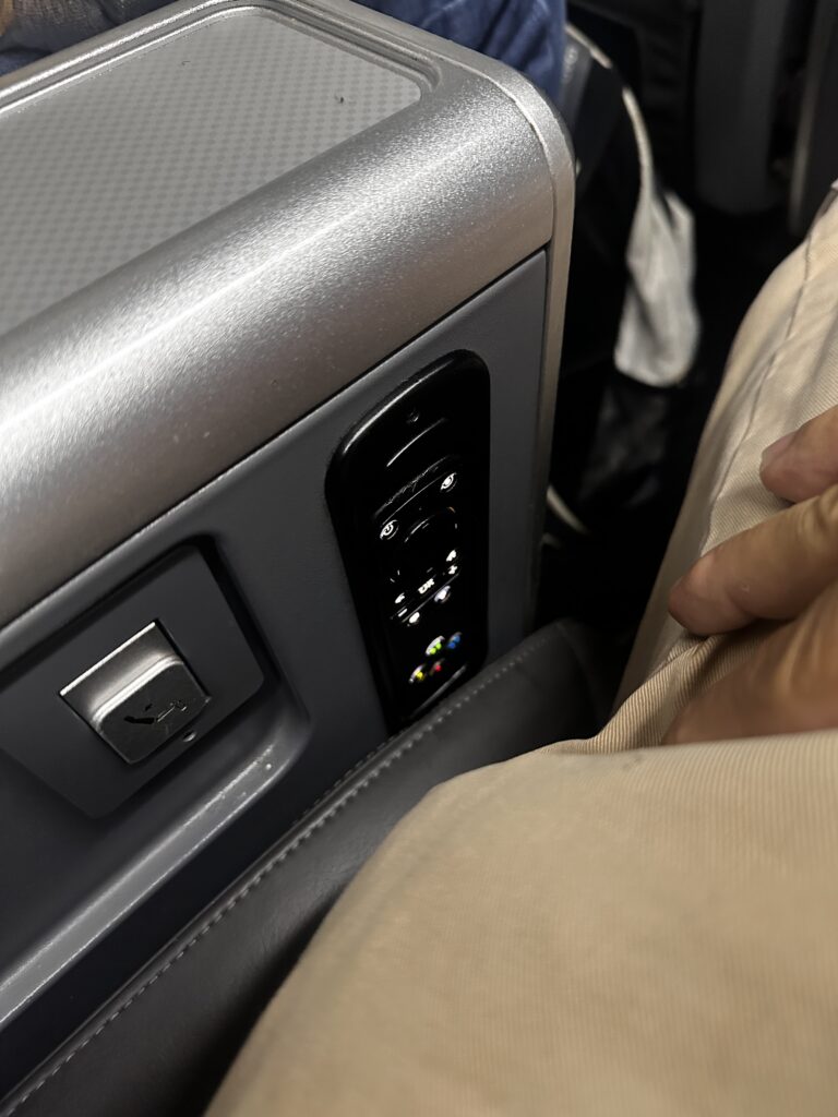 American Airlines DFW-HNL Premium Economy Review | Boeing 777 Hawaii Calling a close up of a button