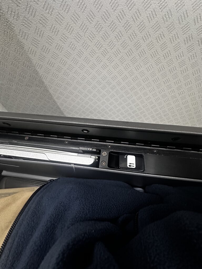 American Airlines DFW-HNL Premium Economy Review | Boeing 777 Hawaii Calling a black object with a light on it