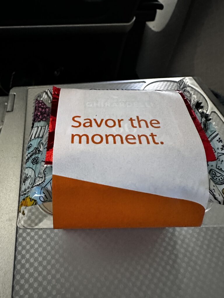 American Airlines DFW-HNL Premium Economy Review | Boeing 777 Hawaii Calling a package of candy on a silver tray