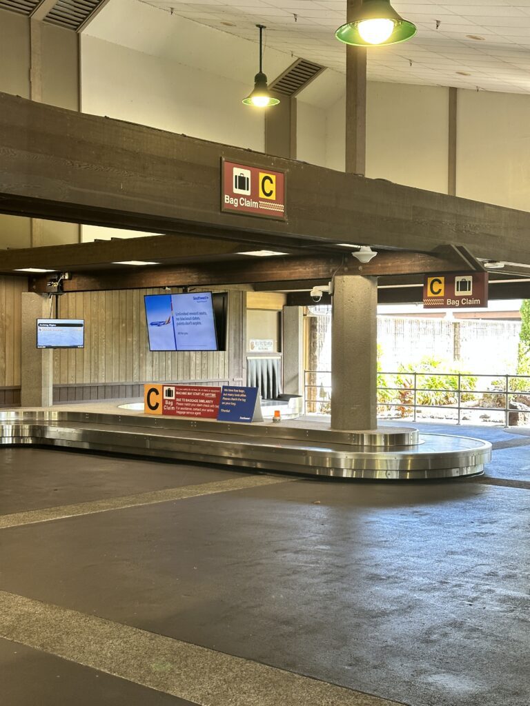 Hilo International Airport Guide (2025) | Big Island Hawai'i (ITO) Hawaii Calling a baggage claim area with a sign